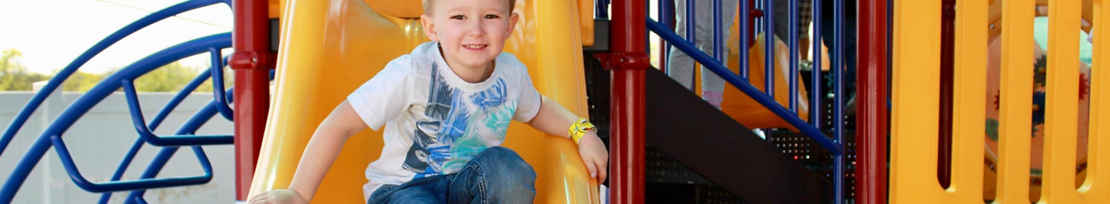 Child on Slide - Community Child Care Services